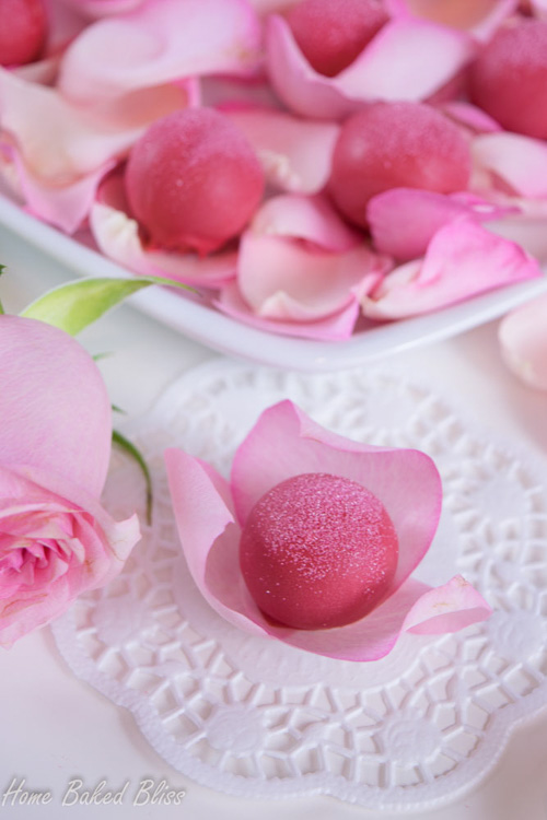 A rose water truffle nestled in rose petals.