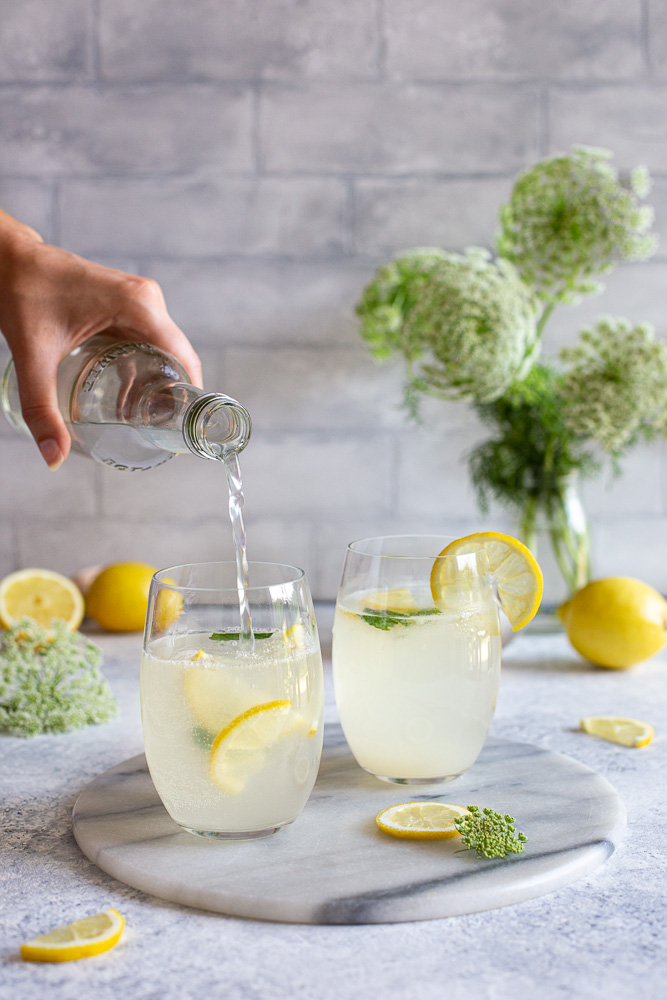 Pouring homemade lemonade into glasses