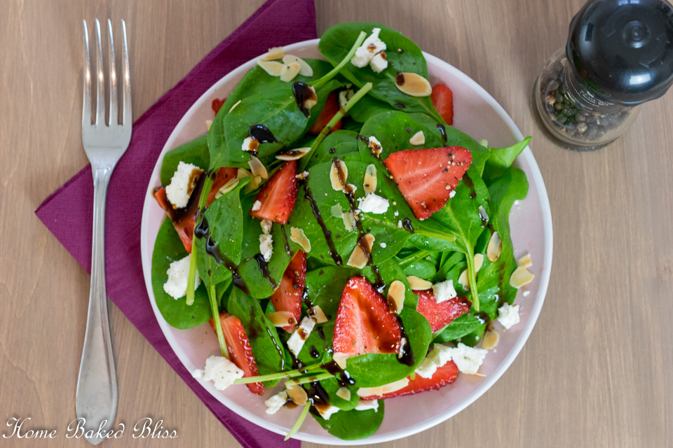Strawberry Feta Spinach Salad on a pink plate.