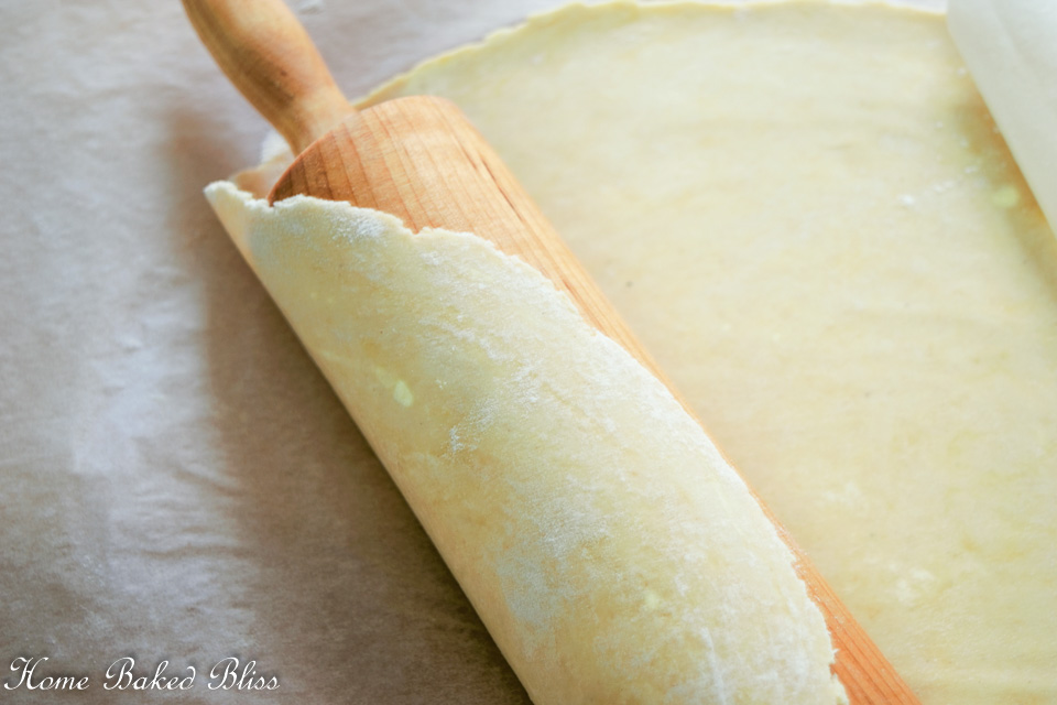Gluten free pie dough rolled onto rolling pin