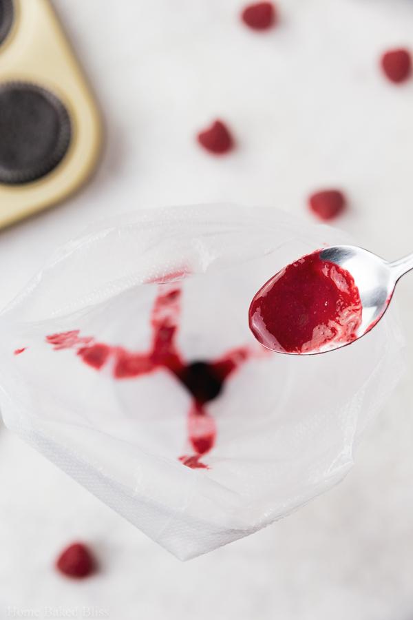 Filling raspberry sauce into piping bag