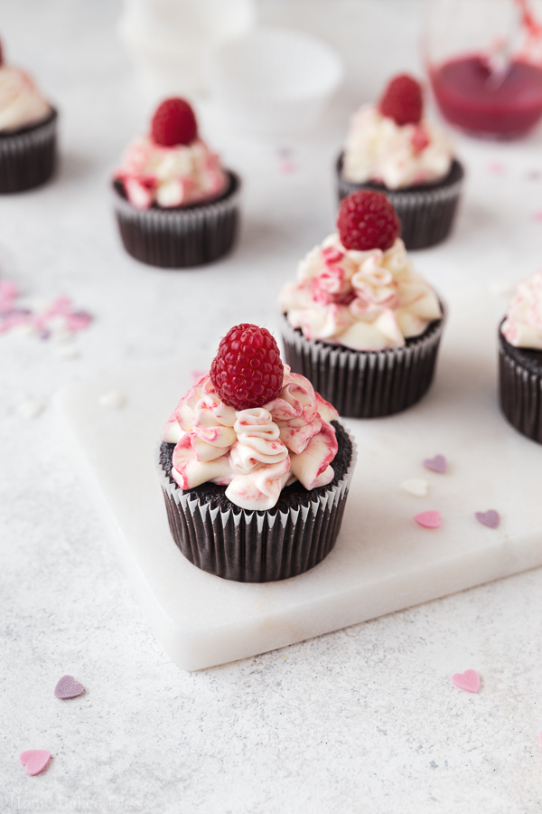 Chocolate raspberry cupcakes on marble serving plate