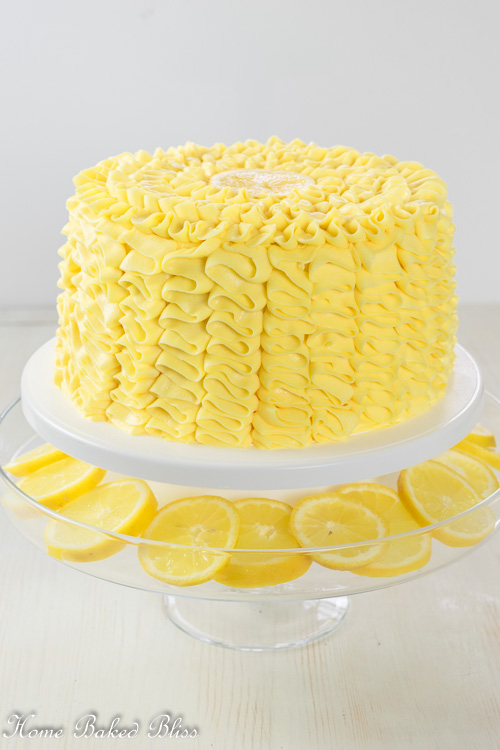 Lemon Ruffle Cake on display on a white cake stand