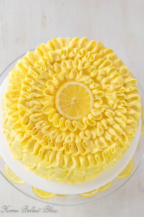 Lemon ruffle cake garnished with a fresh lemon slice.