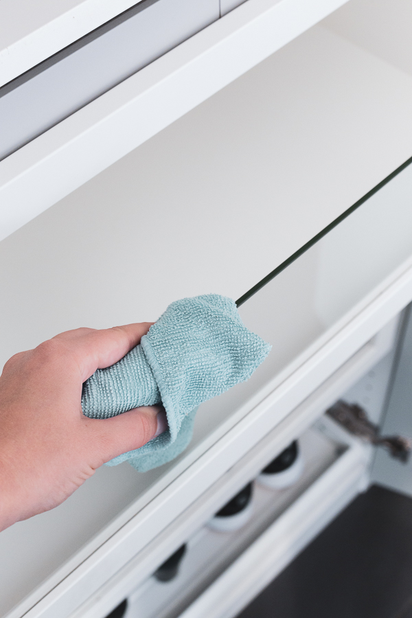 Cleaning the closet with a microfibre cloth