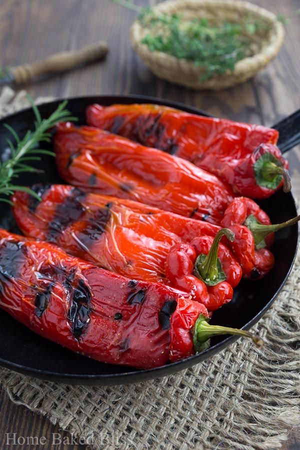 A closeup of the grilled peppers with feta in a black pan