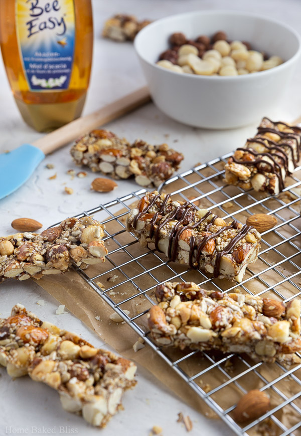 Honey nut bars drizzled with chocolate on parchment paper