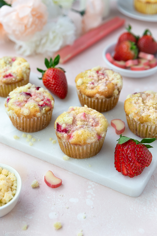 Strawberry Rhubarb Streusel Muffins on white stone serving plate