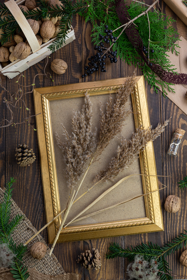 A gold frame decorated with ornamental grass