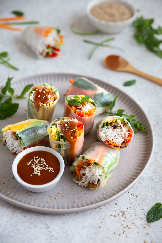 Vegan rice paper rolls drizzled with peanut sauce