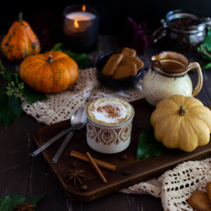 Vegan Pumpkin Spice Latte with Cinnamon on a wooden plate