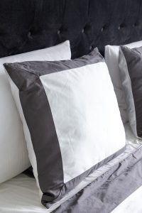 White and grey pillow cover.