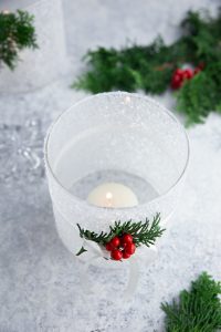 DIY frosted candle jar with a lit tea candle