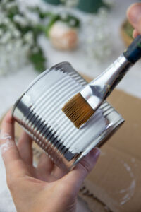 Painting a tin can with white acrylic paint