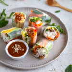 Vegan rice paper rolls drizzled with peanut sauce