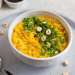 Carrot Risotto with a hazelnut Gremolata topping on a stone tray
