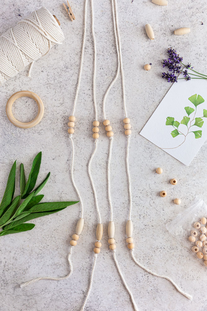 Materials for DIY herb drying rack on a white surface