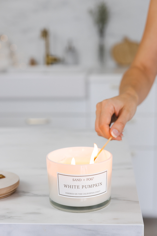 Lighting a candle for a cozy fall mood