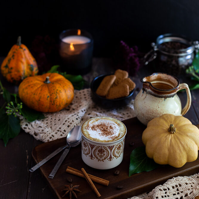 Vegan Pumpkin Spice Latte with Cinnamon on a wooden plate